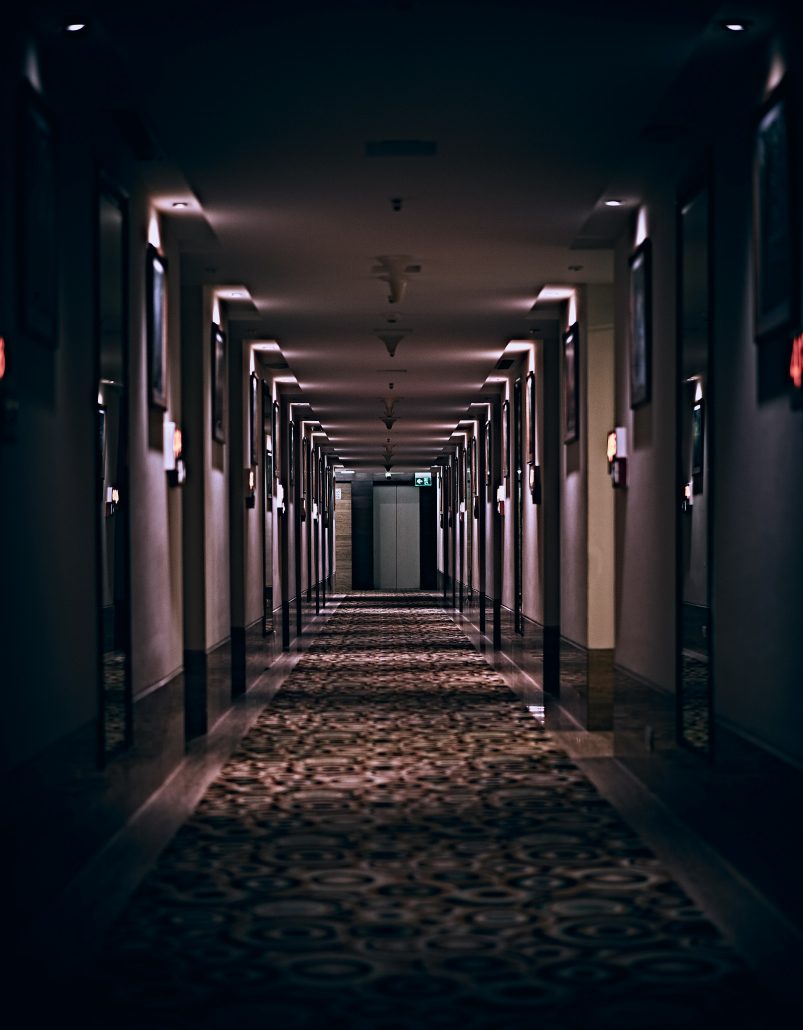 An atmospheric photo of a long hotel corridor